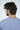 A man with captured from behind wearing a Jaxson Maximus Big League Notched V-Neck Short Sleeve tee in light blue against a plain white backdrop.