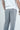 A person wearing a white t-shirt and Deerfield Jogger Charcoal Gray sweatpants is shown from the back. The joggers have an embroidered logo on the top right pocket, set against a plain light gray background.