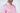 A person wears the West Palm Polo: Dolphin Tail Pink featuring a subtle chevron pattern and bespoke English spread collar. Made of luxury performance fabric with three buttons, their face is partially visible against a plain white background.