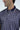 A person wears the Sarasota Polo: Golf Girl Navy, showcasing a navy design with golf figures. Crafted from luxury performance fabric with four-way stretch, it features a dark collar with white trim. The persons face is partially visible as they glance sideways.