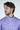A man with wavy brown hair and a beard looks to the side, wearing a Jaxson Maximus Key West 1/4 Zip: Golf Cart Palm sweater in vibrant purple with a white palm tree design. The stylish piece stands out against the plain white background.