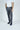 A person in a white T-shirt, Everglades Drawstring Pant Gray with hidden pockets, and dark blue sneakers stands on a plain light gray background. The breathable cotton blend pants offer comfort as they face forward with hands at their sides.